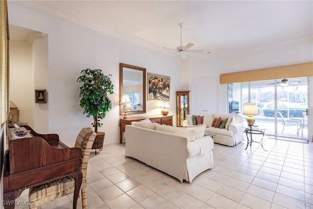 tiled living room featuring crown molding and ceiling fan