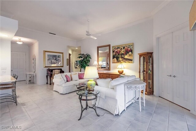 tiled living room featuring ceiling fan and ornamental molding