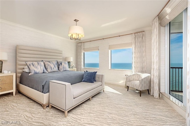 carpeted bedroom featuring access to outside, a water view, ornamental molding, and a notable chandelier