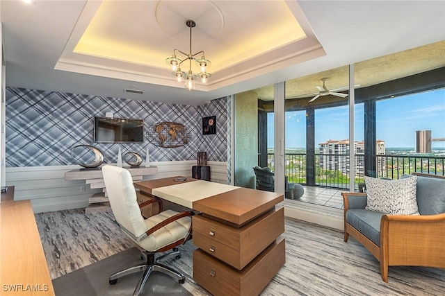 office featuring hardwood / wood-style flooring and a raised ceiling