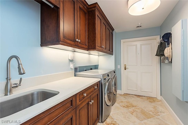 washroom featuring cabinets, separate washer and dryer, and sink