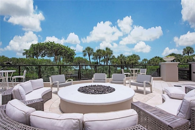 view of patio featuring an outdoor living space with a fire pit