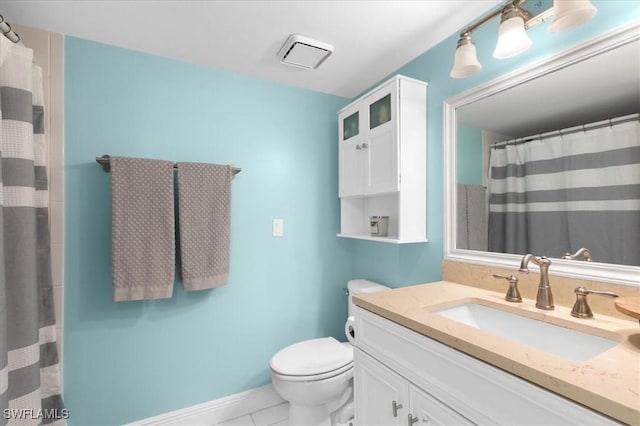 bathroom with toilet, tile patterned floors, and vanity