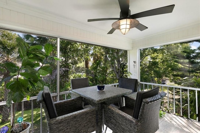 sunroom / solarium featuring ceiling fan