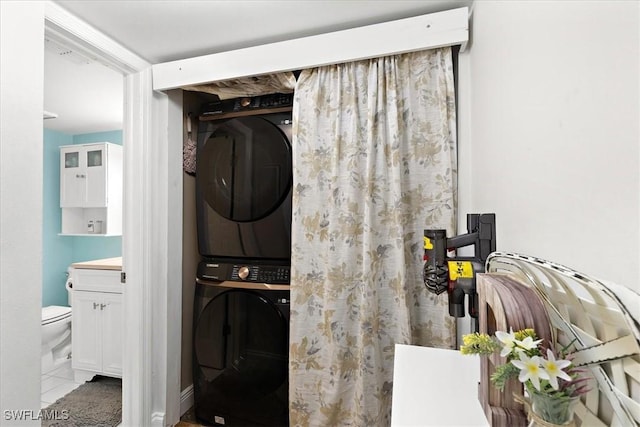 laundry area featuring stacked washer and clothes dryer