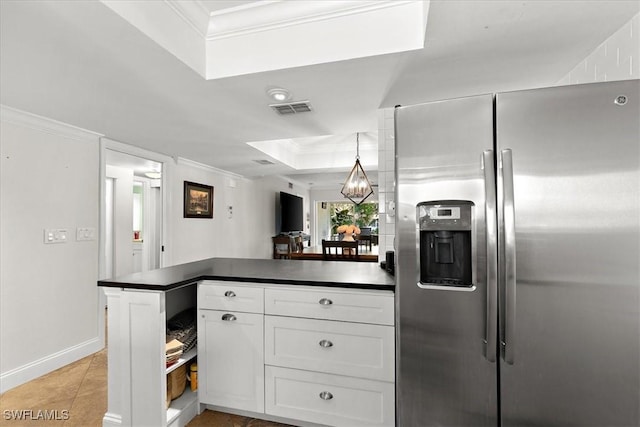 kitchen featuring white cabinetry, stainless steel fridge with ice dispenser, ornamental molding, kitchen peninsula, and a tray ceiling