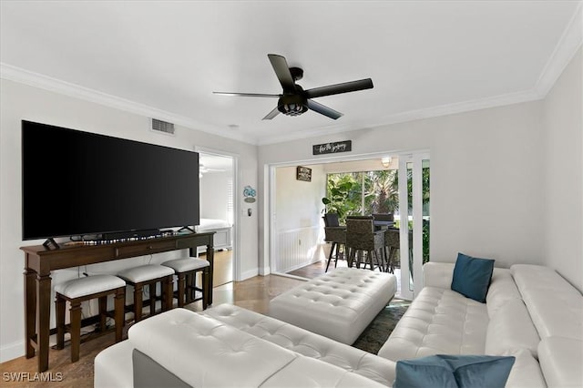 living room with ceiling fan, ornamental molding, and hardwood / wood-style flooring