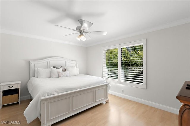 bedroom with ceiling fan, light wood-type flooring, and crown molding