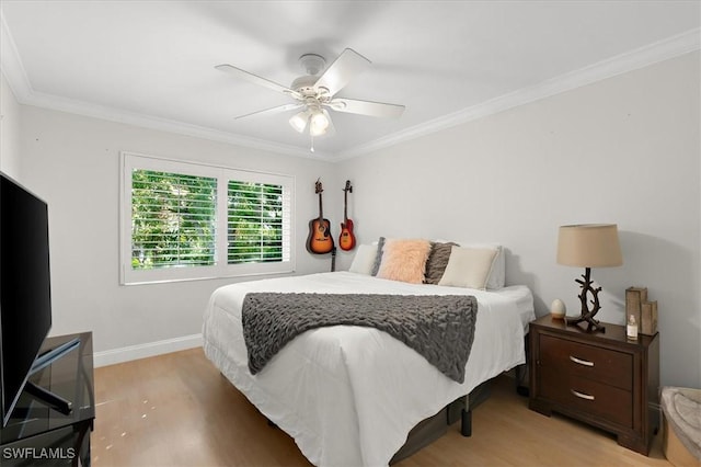 bedroom featuring light wood-type flooring, ceiling fan, and crown molding