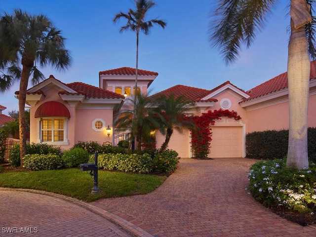 mediterranean / spanish house with a garage