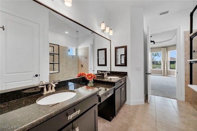 bathroom featuring tile patterned floors, vanity, and tiled shower