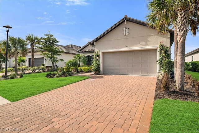 view of front of house featuring a front lawn and a garage