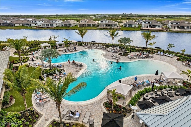 view of swimming pool featuring a water view