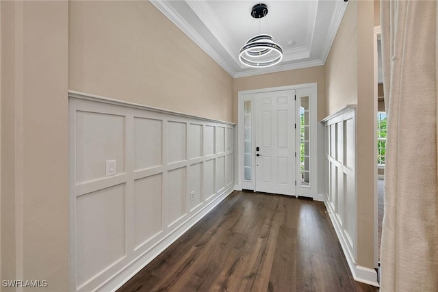 entrance foyer featuring dark hardwood / wood-style flooring and crown molding