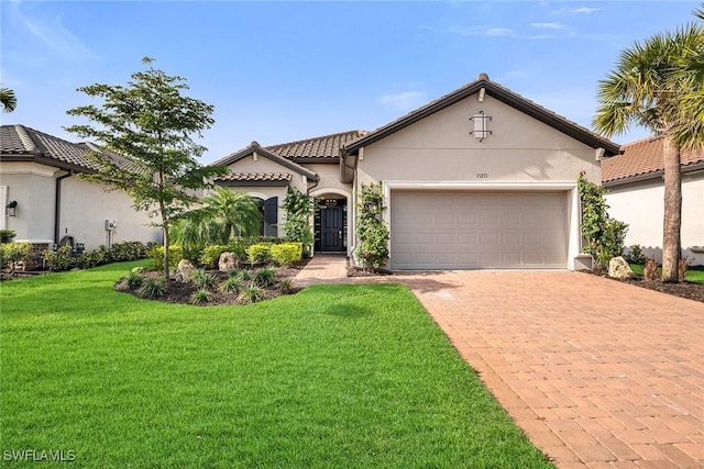 mediterranean / spanish-style home with a garage and a front lawn