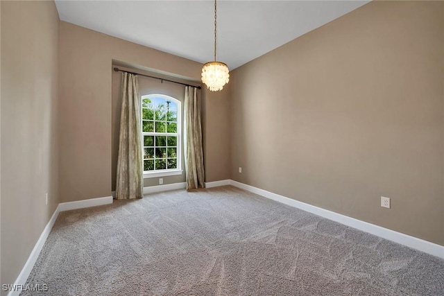 unfurnished room with light carpet and a chandelier