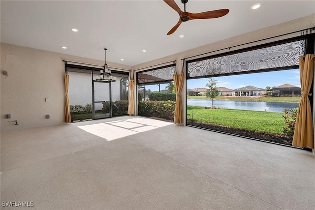 unfurnished sunroom with a water view and ceiling fan