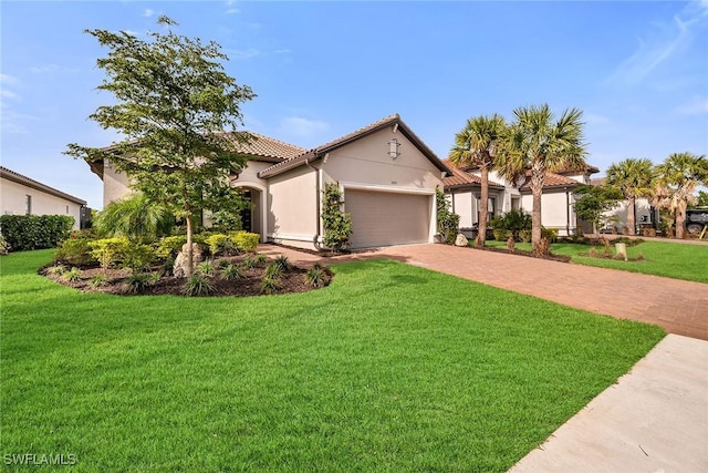 mediterranean / spanish home with a garage and a front yard