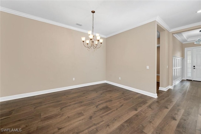 unfurnished room with crown molding, dark hardwood / wood-style floors, and a chandelier