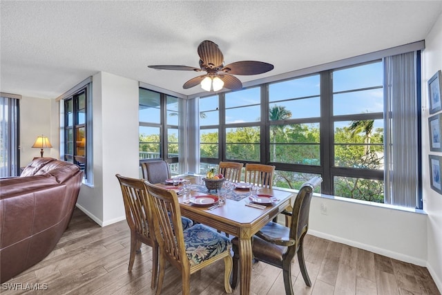 dining room with wood-type flooring, ceiling fan, and a healthy amount of sunlight