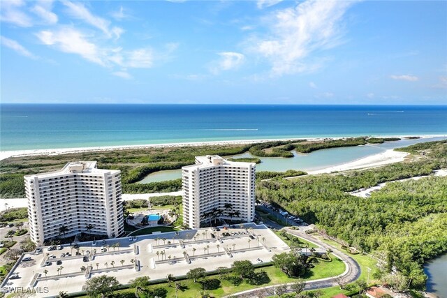 drone / aerial view featuring a beach view and a water view