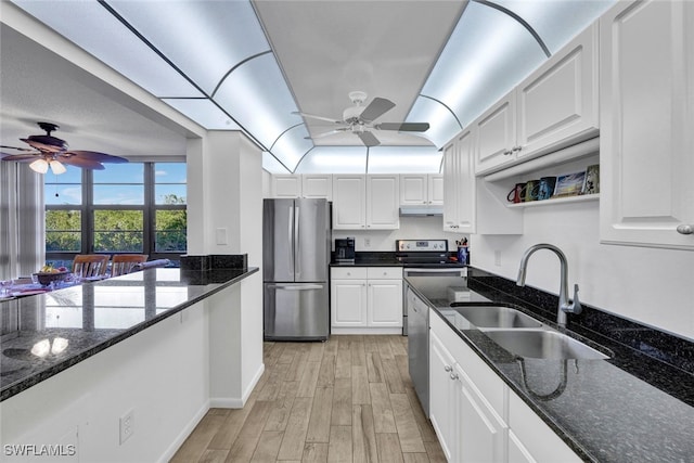 kitchen featuring appliances with stainless steel finishes, white cabinetry, and sink