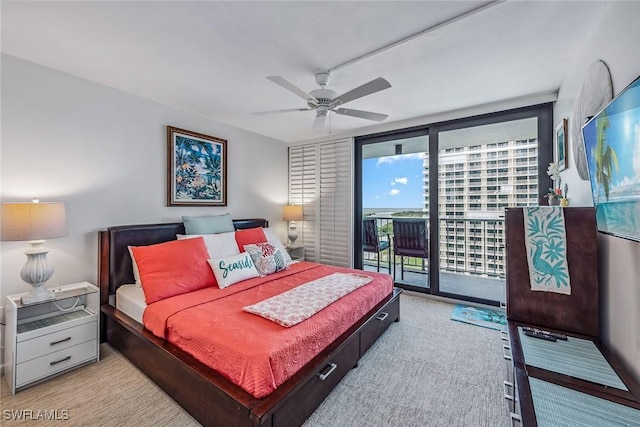 bedroom with access to exterior, expansive windows, and ceiling fan