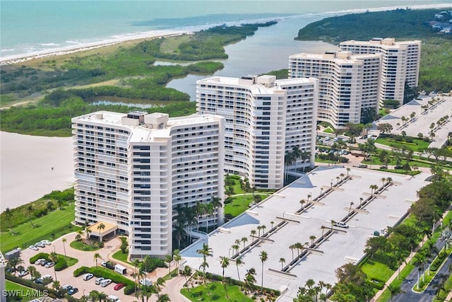 drone / aerial view with a water view and a beach view