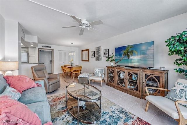 living room with ceiling fan and light tile patterned floors