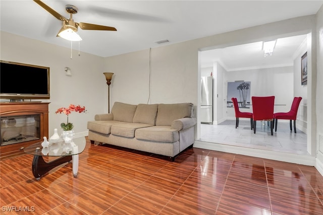 living room with crown molding and ceiling fan