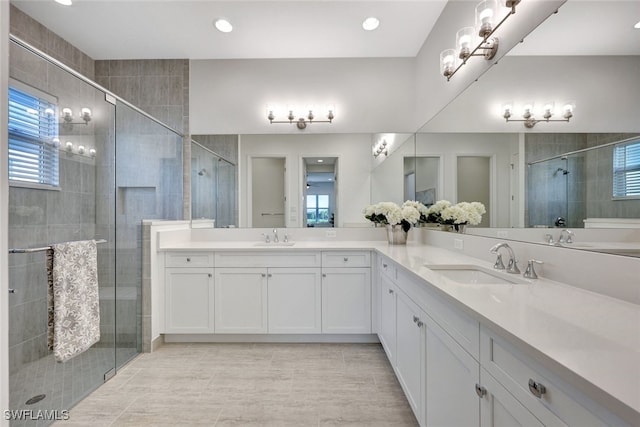 bathroom with tile patterned floors, vanity, and a shower with shower door