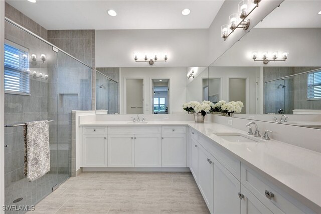 12418 Dahlia Ct, Naples, FL 34120 - full bathroom featuring double vanity, a shower stall, plenty of natural light, and recessed lighting