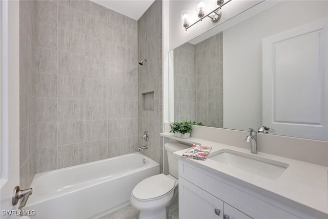 full bathroom with vanity, tiled shower / bath combo, and toilet