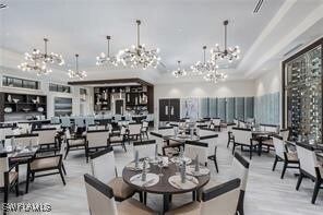 12418 Dahlia Ct, Naples, FL 34120 - dining space featuring a chandelier