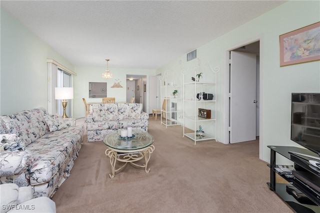 carpeted living room featuring a textured ceiling