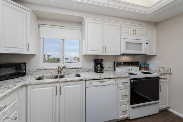 kitchen featuring white cabinetry, sink, light stone counters, and white appliances