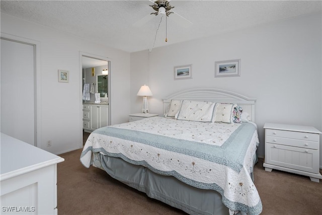 bedroom with ensuite bathroom, ceiling fan, a textured ceiling, and dark colored carpet