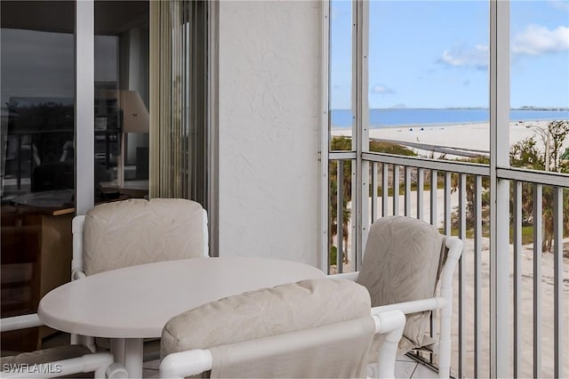 balcony with a beach view and a water view