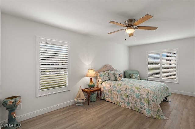 bedroom with ceiling fan and light hardwood / wood-style floors