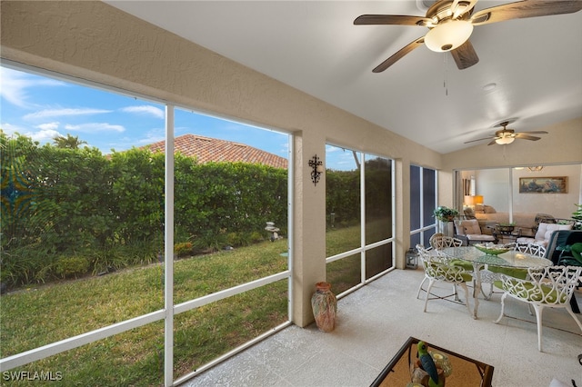 unfurnished sunroom featuring vaulted ceiling