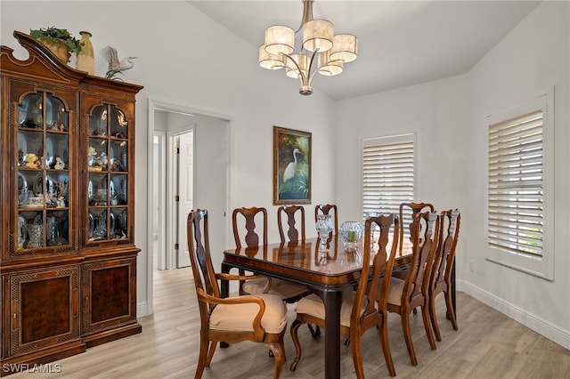 dining area featuring light hardwood / wood-style flooring, plenty of natural light, and a chandelier