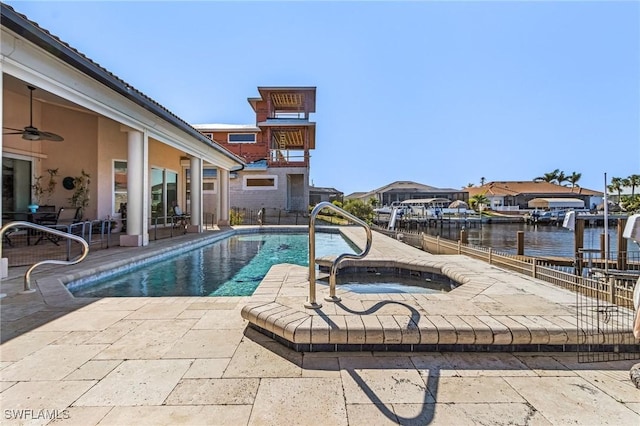 view of pool with a water view, ceiling fan, and a patio area