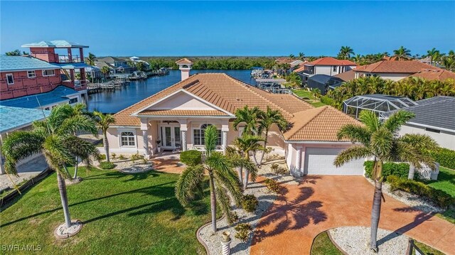 mediterranean / spanish-style house with a water view, french doors, and a garage