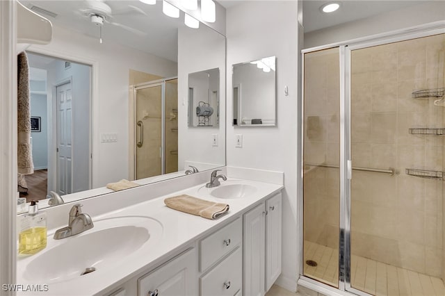 bathroom with vanity, ceiling fan, and a shower with door