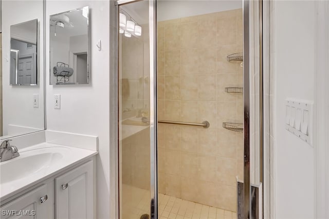 bathroom with a shower with door and vanity