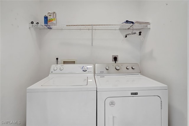 clothes washing area with washer and clothes dryer