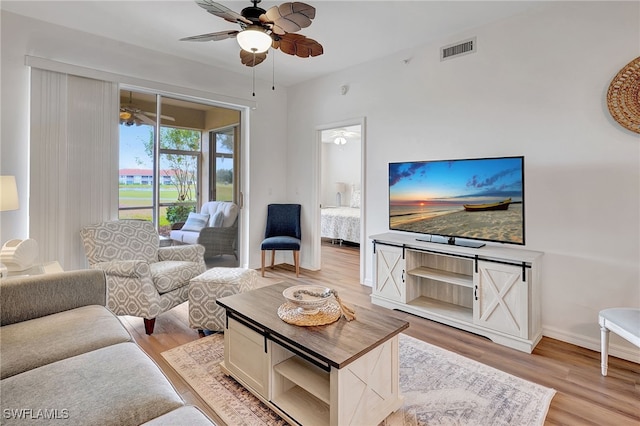 living room with ceiling fan and light hardwood / wood-style floors