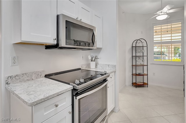 kitchen featuring ceiling fan, white cabinets, light stone counters, and appliances with stainless steel finishes