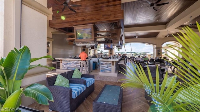 exterior space with an outdoor living space, ceiling fan, and an outdoor bar