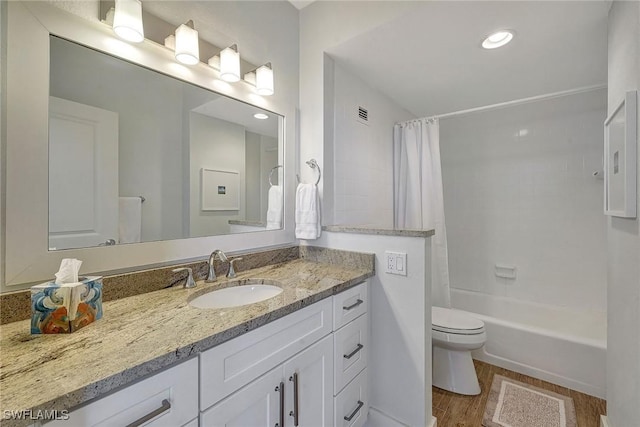 full bathroom featuring toilet, vanity, shower / tub combo with curtain, and hardwood / wood-style floors